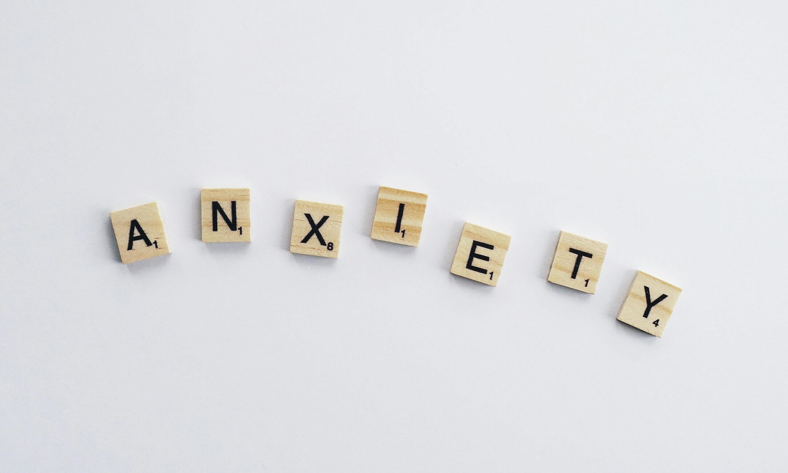 Scrabble pieces that spell "Anxiety"