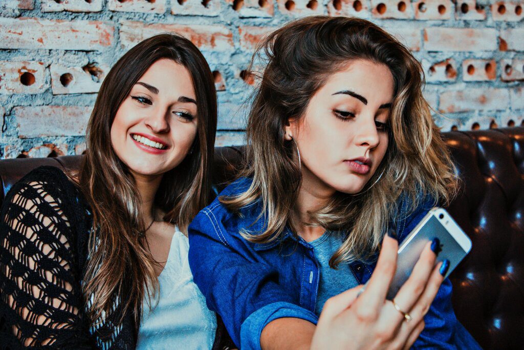 Two girls posing seductively for a selfie - Self-Esteem